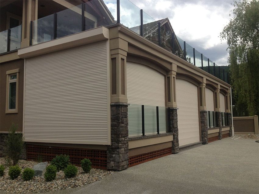 Beige roll-up garage doors installed on a Toronto home
