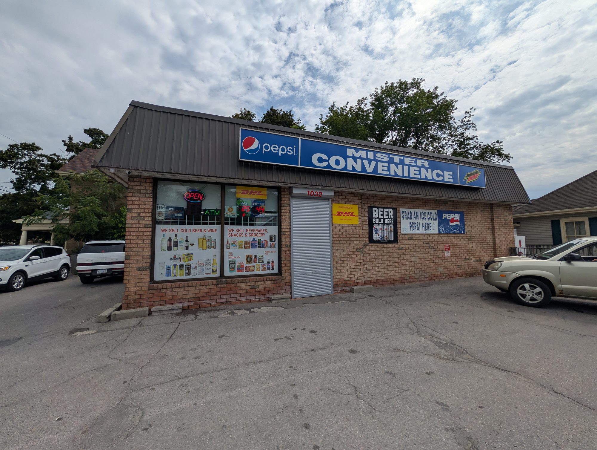 Grey roll-up security shutter on a convenience store door