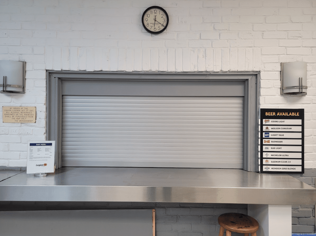 Outdoor bar counter protected by a roll-up security shutter