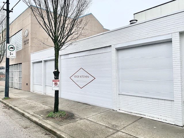 Branded roll-up shutter on Edge Kitchen restaurant storefront