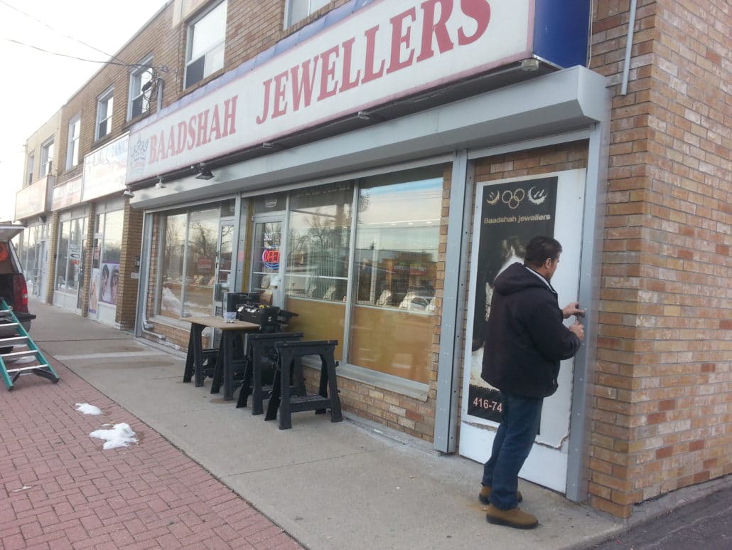 Roll-up shutter on a jewelry store with outdoor patio seating