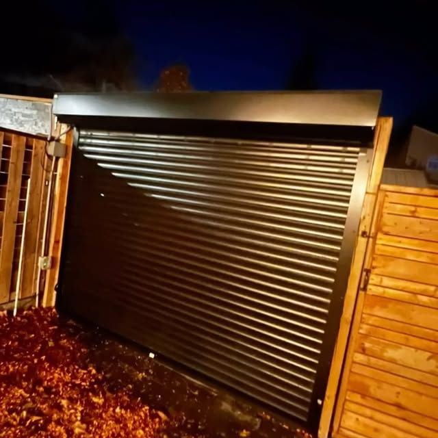 Roll-up shutter on a laneway garage photographed at night