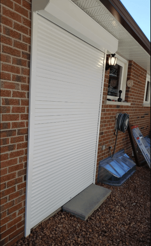 Roll-up shutter on a patio door of a brick residential home