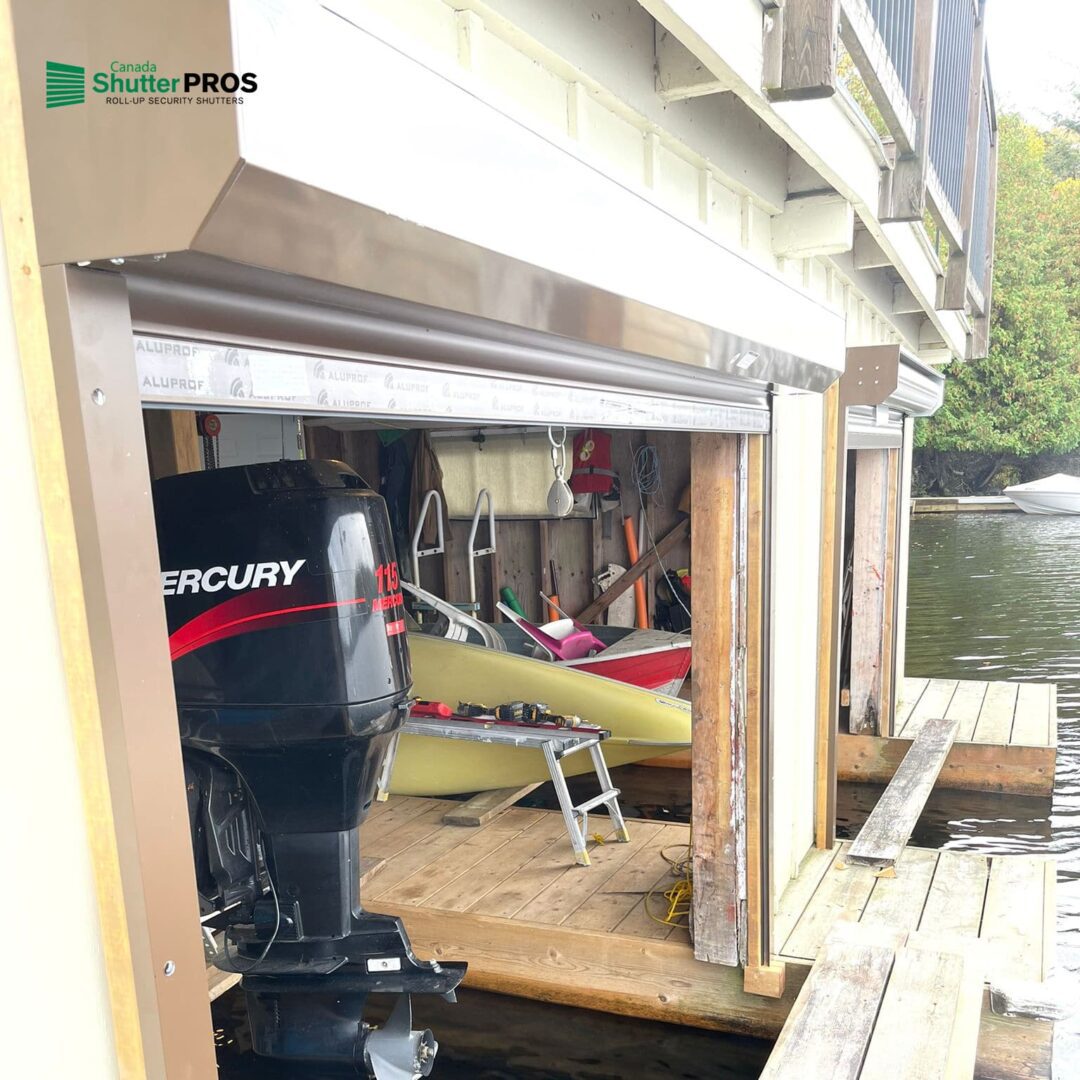 Roll-up shutter fully raised on a boathouse with boat visible inside
