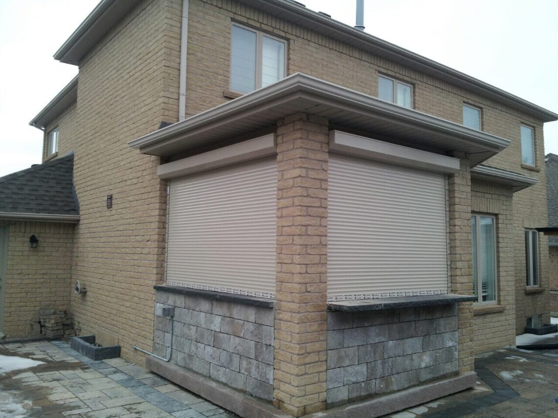 Roll-up shutter installed on a brick home window exterior