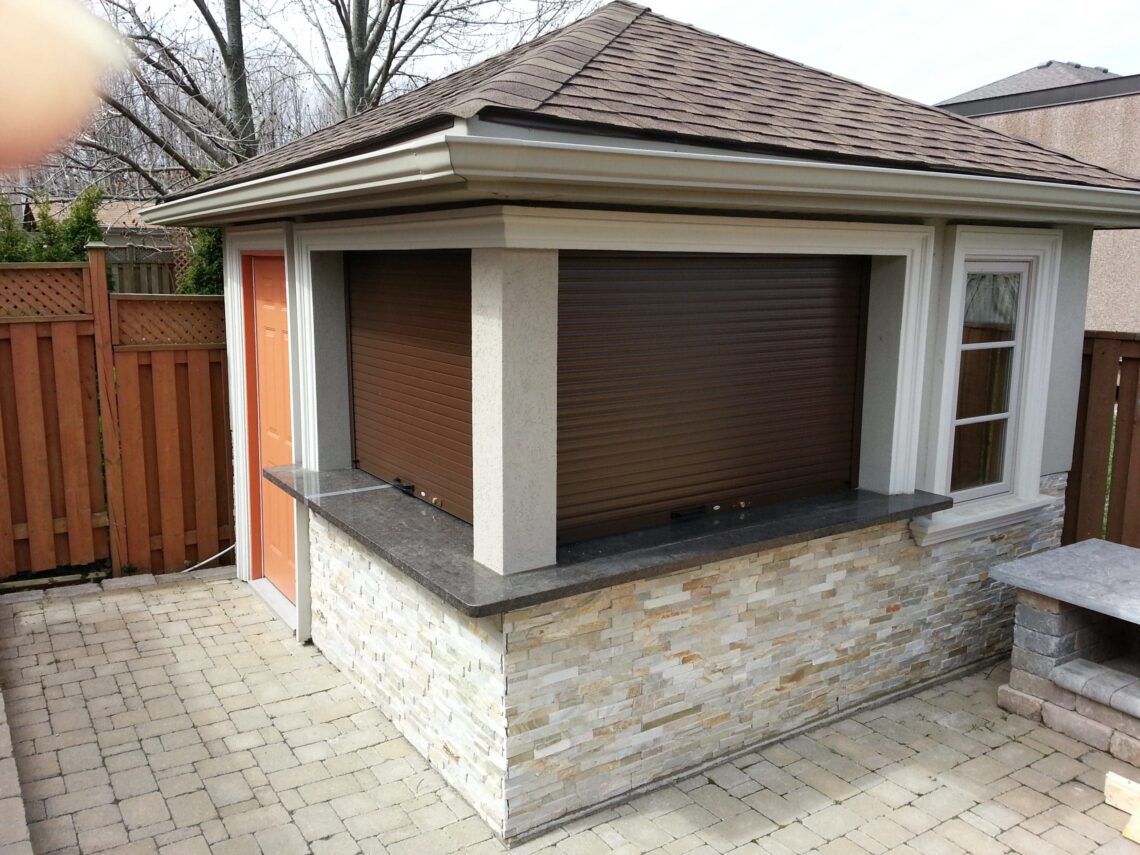 Roll-up shutter on a brick cabana photographed at sunset