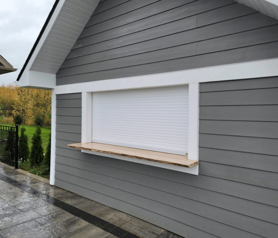 Roll-up shutter installed on a cabana under a pergola structure