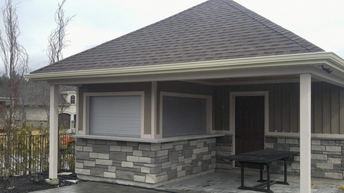 Roll-up shutter on a patio pergola with stone column details
