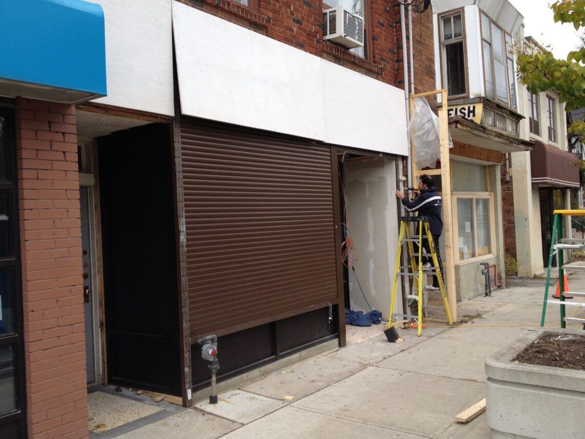 Commercial storefront secured with an aluminum roll-up shutter