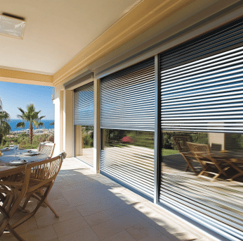 Roller shutters open on patio doors showing garden view