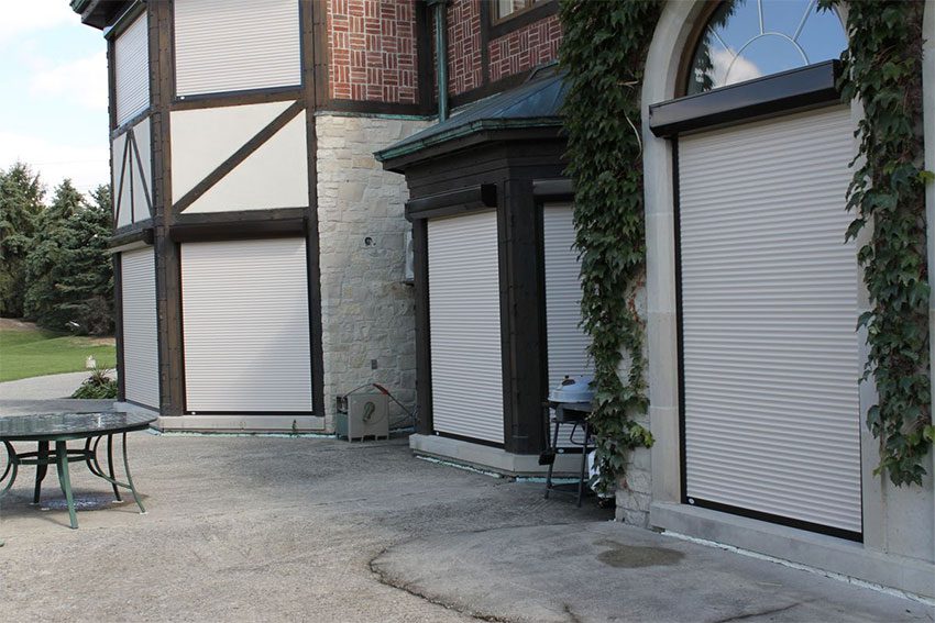Roller shutters installed on windows and doors of a home exterior