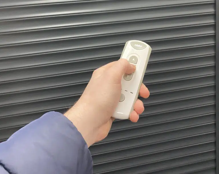 Handheld remote control used to operate a motorized roll-up shutter