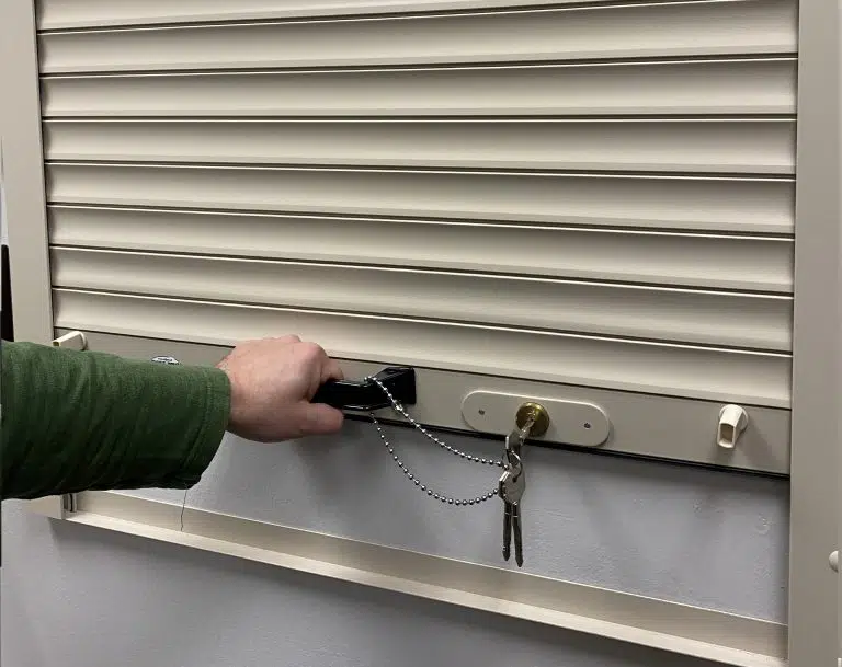 Spring-loaded roll-up shutter opened and closed by lifting the bottom bar