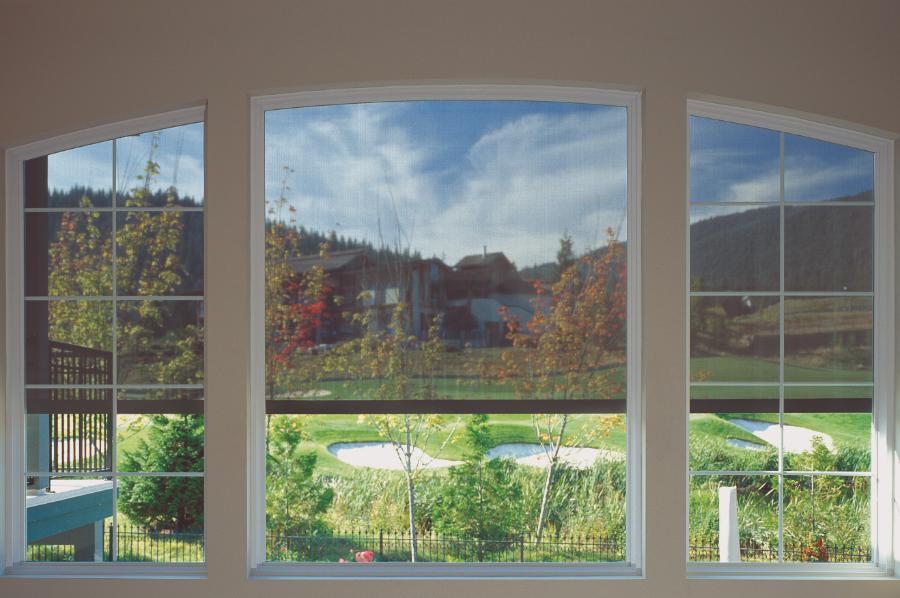 Retractable screens on large windows, seen from inside