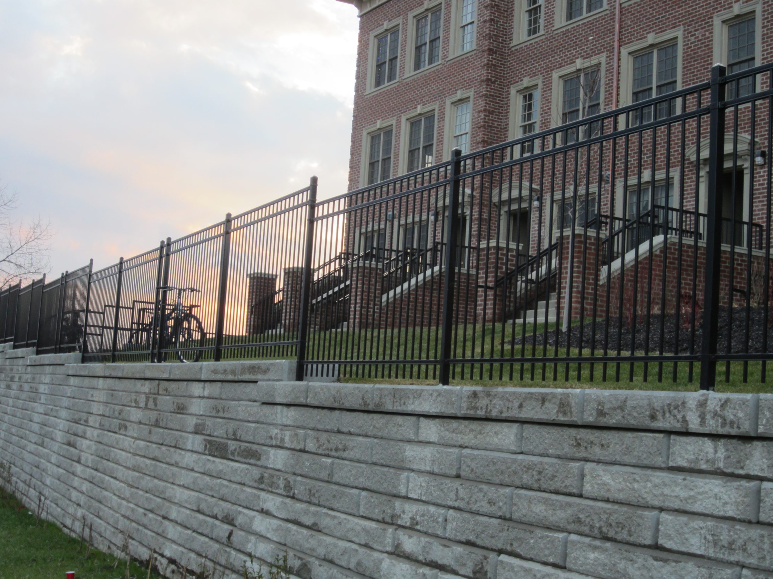 Black louvered equipment enclosure protecting exterior mechanical assets